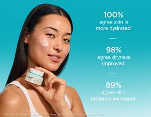 Young woman holding Curél Intensive Moisture Facial Cream with a swatch of moisturiser on cheek